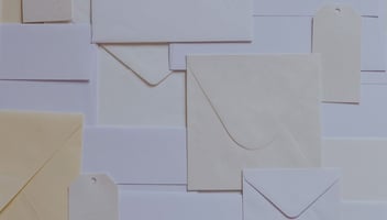 Mail paper letters envelopes stacked in a mess