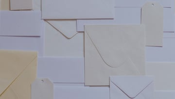 Mail paper letters envelopes stacked in a mess