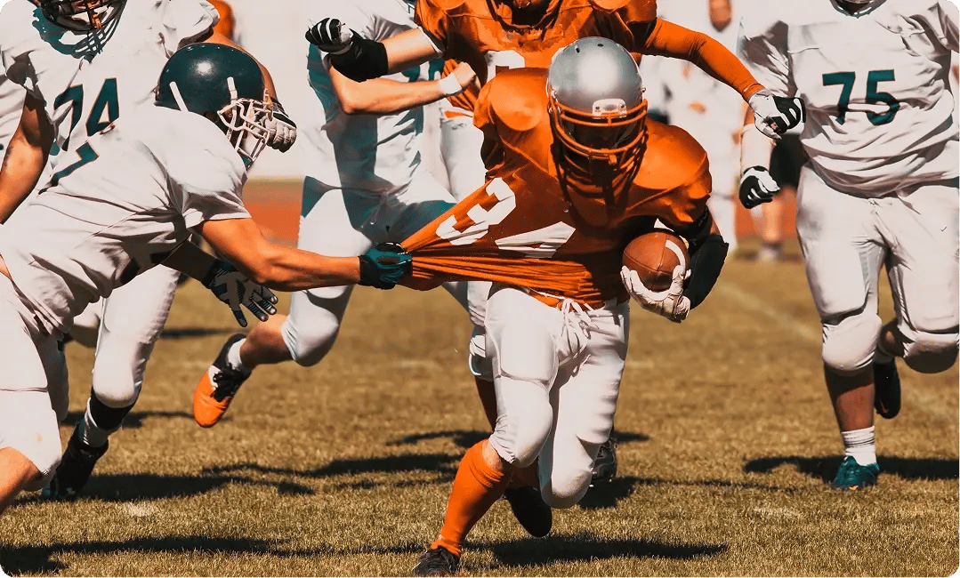 NFL Football teams running against each other in a match-1