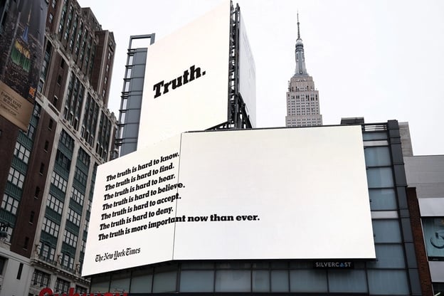 The New York Times "The truth is hard" campaign billboard on a skyscraper wall