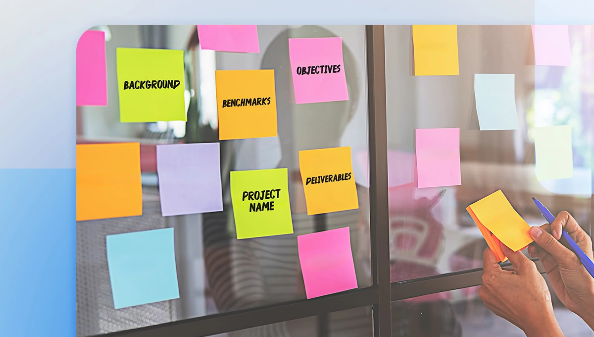 Sticky notes with creative brief parameters on a window glass